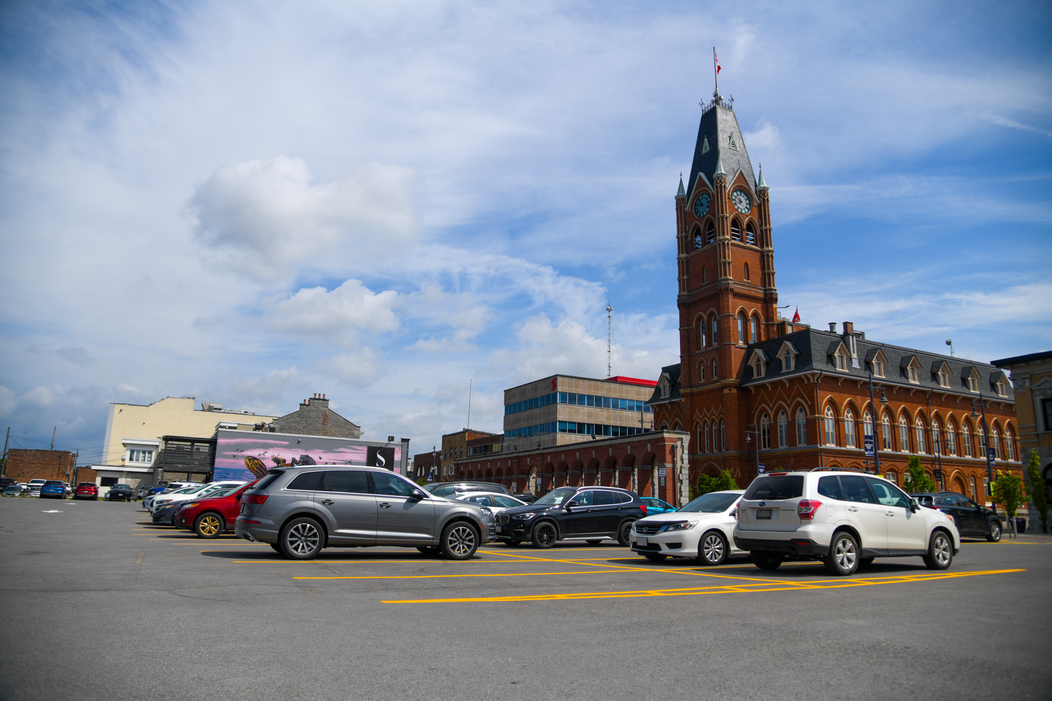 Photo of parking lot with City Hall in the background.