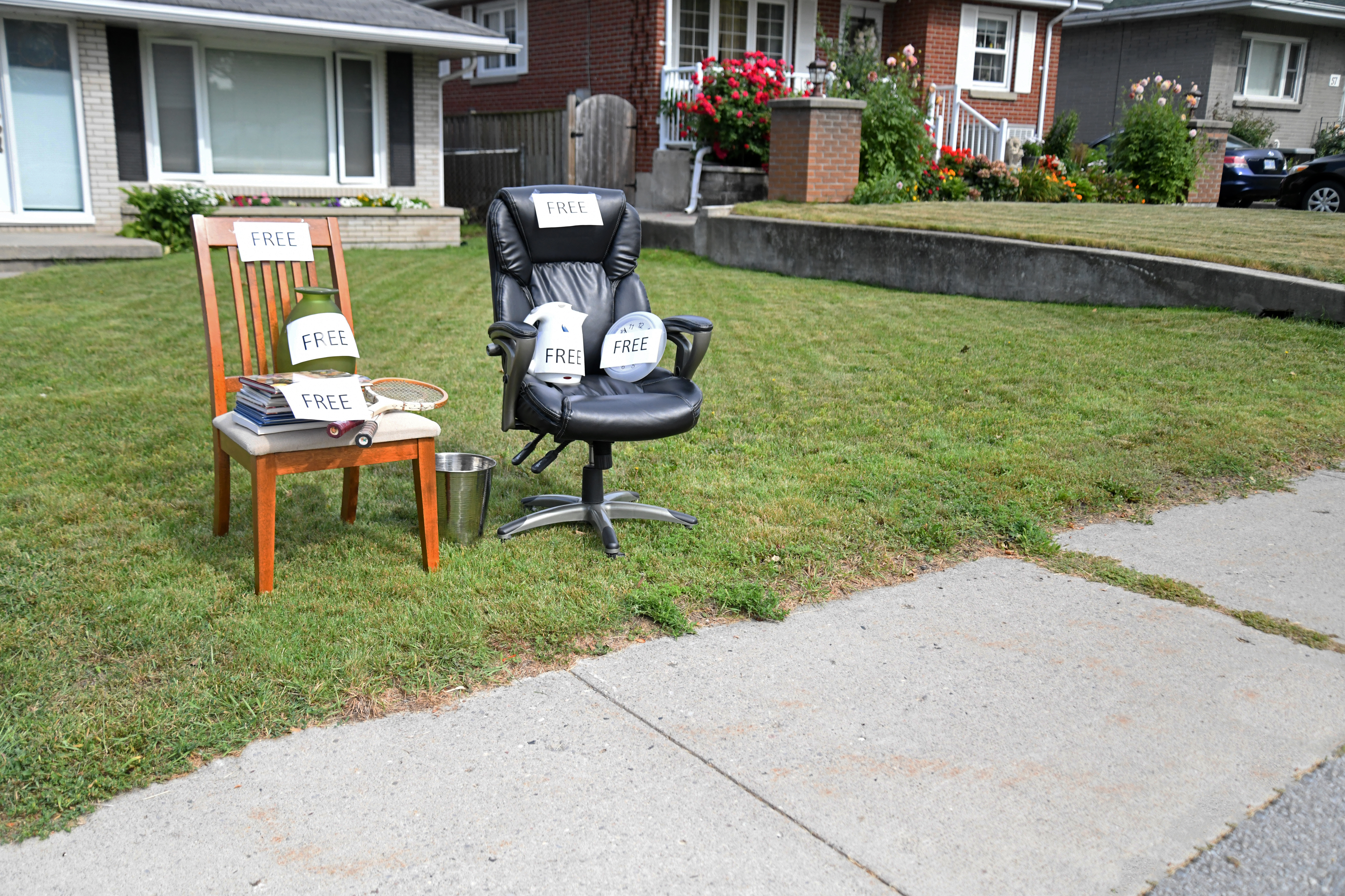 Chairs, books and assorted household goods labeled "free"