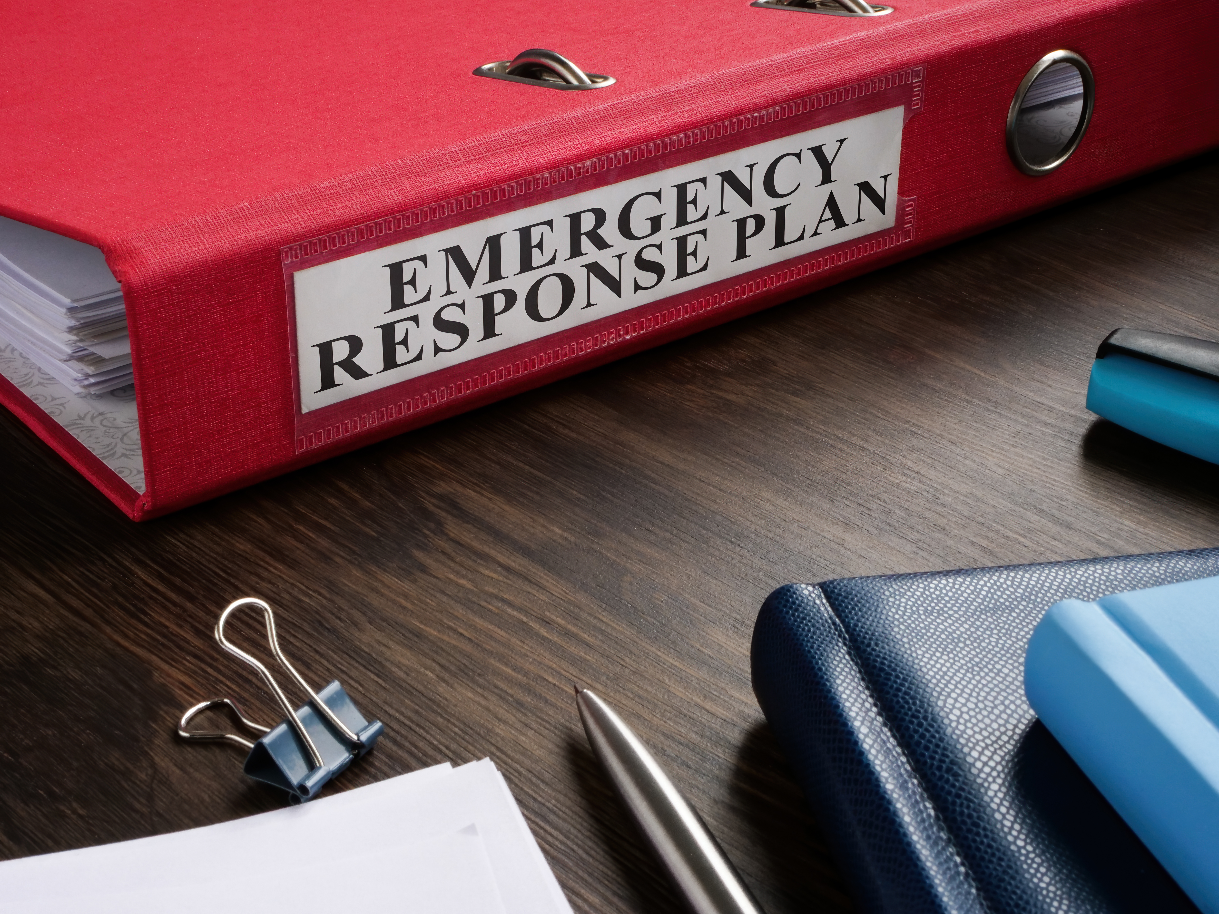 Binder labeled Emergency Response Plan on a table