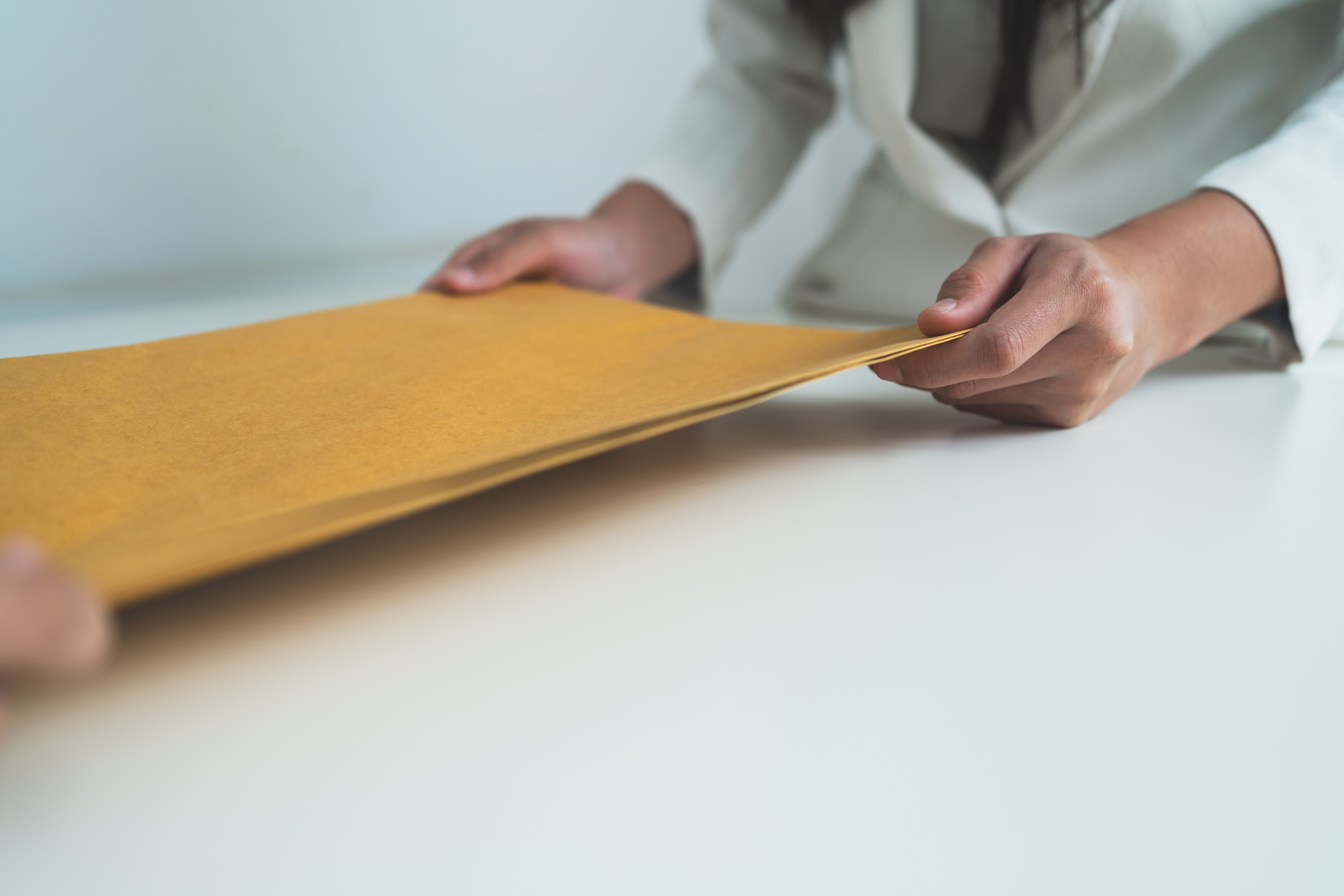 Person handing over envelope