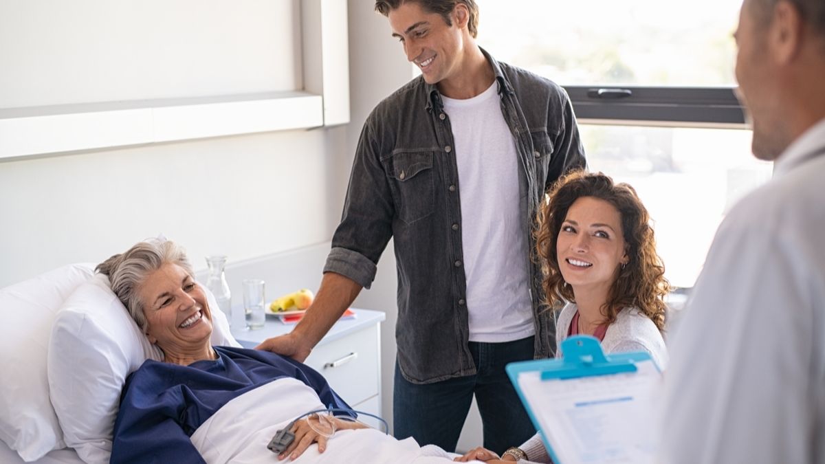 Patient and family smile at doctor