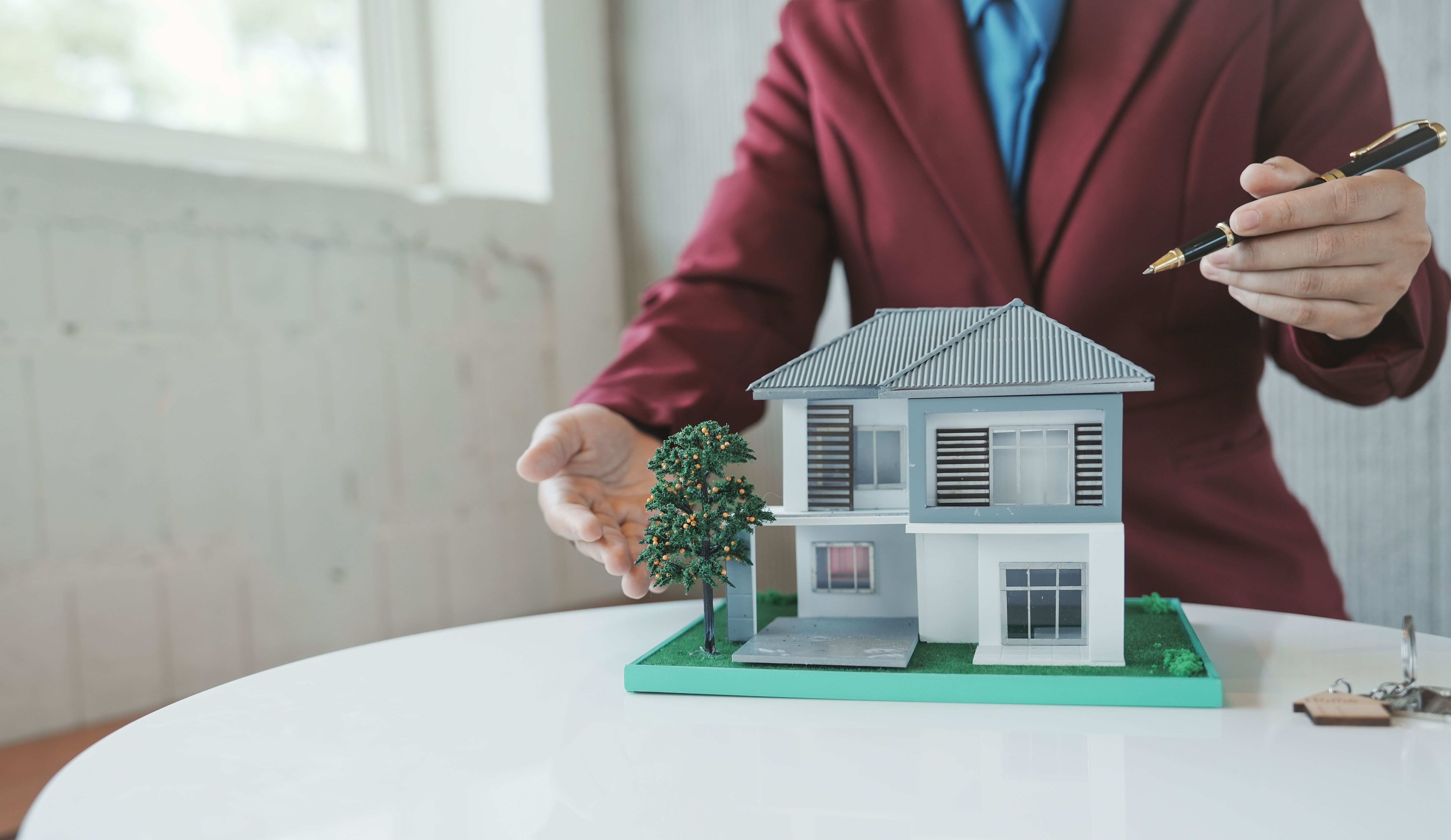 Person pointing to model home