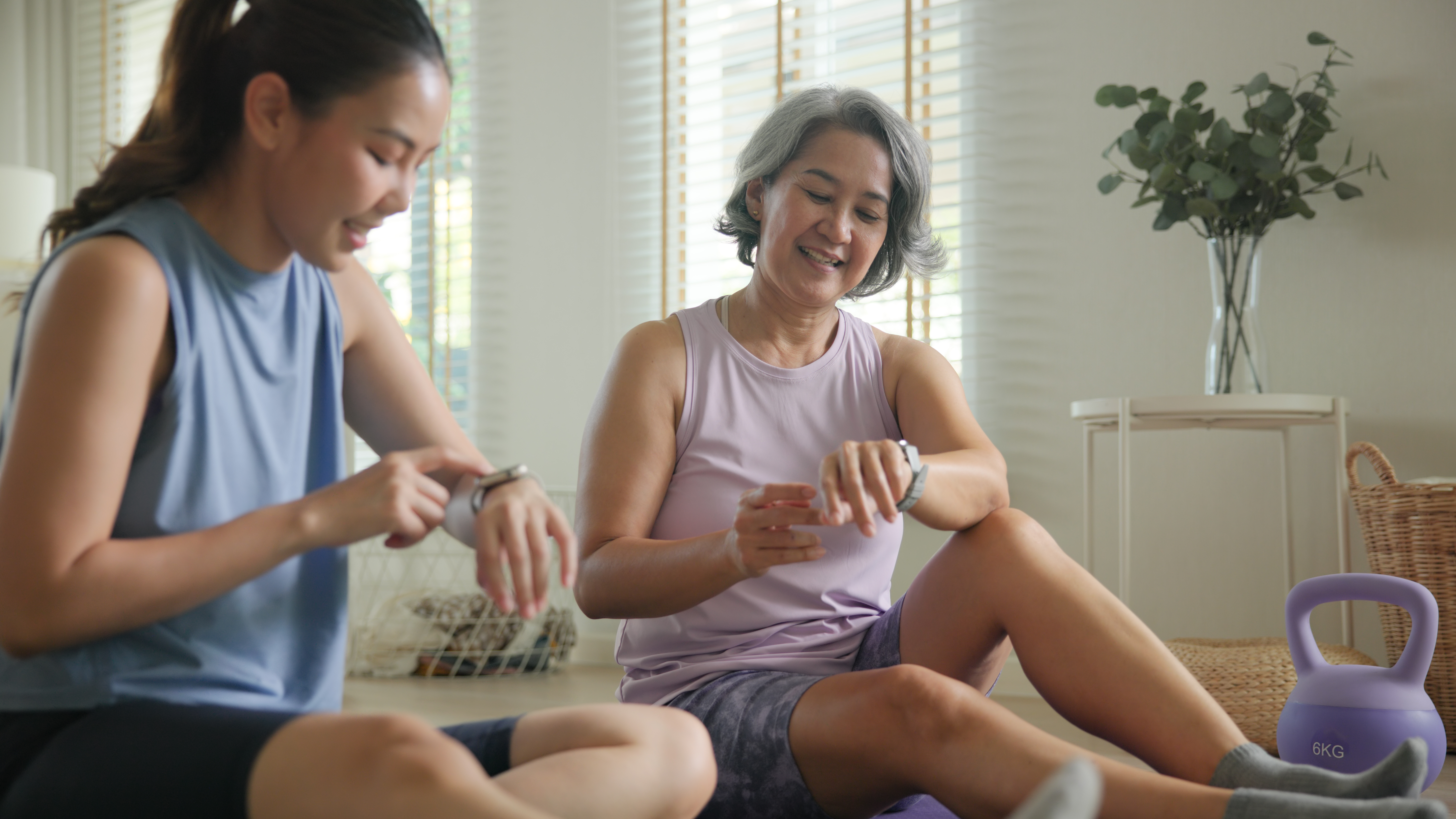 Women in workout attire checking smart watches