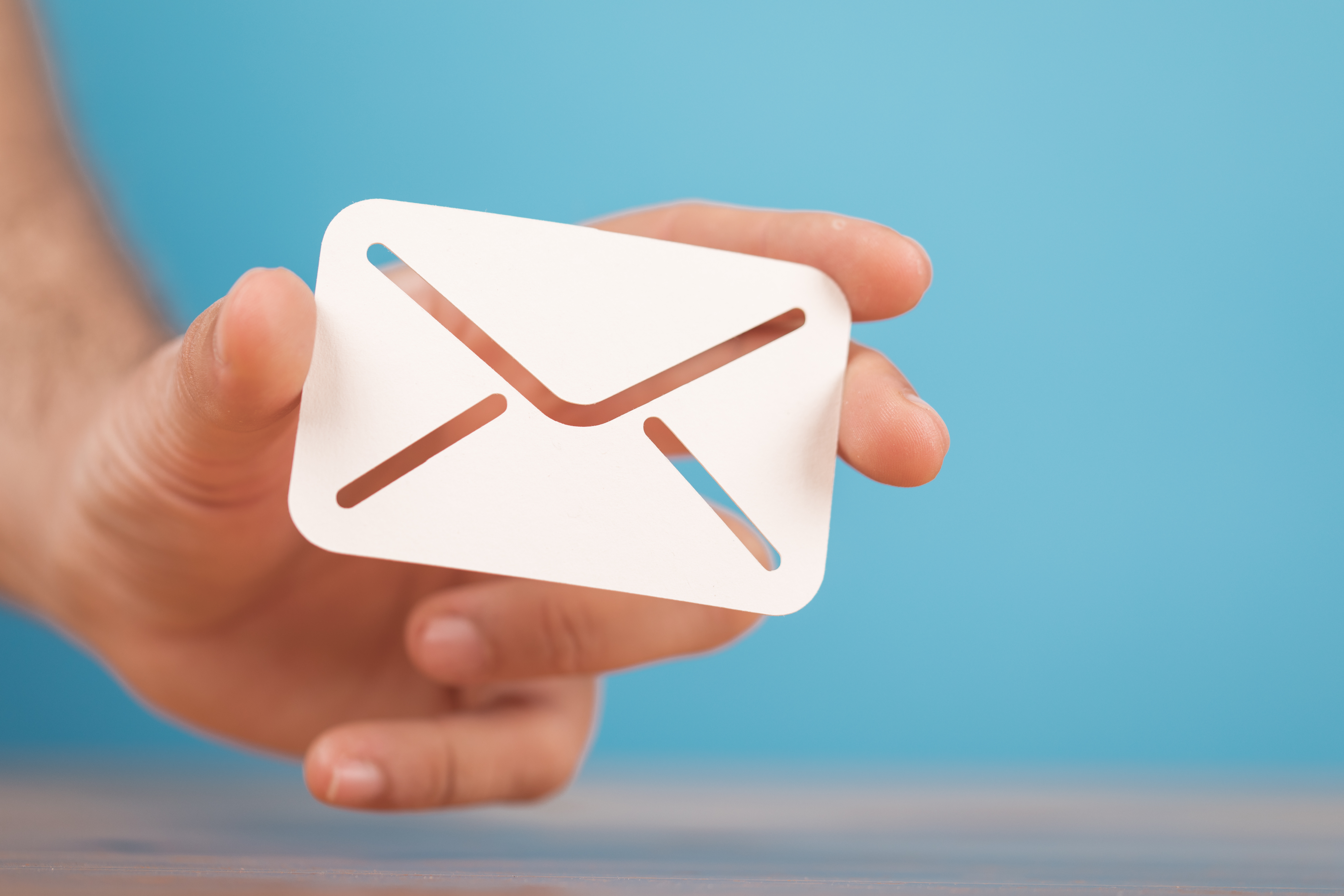 Person holding mail shaped icon