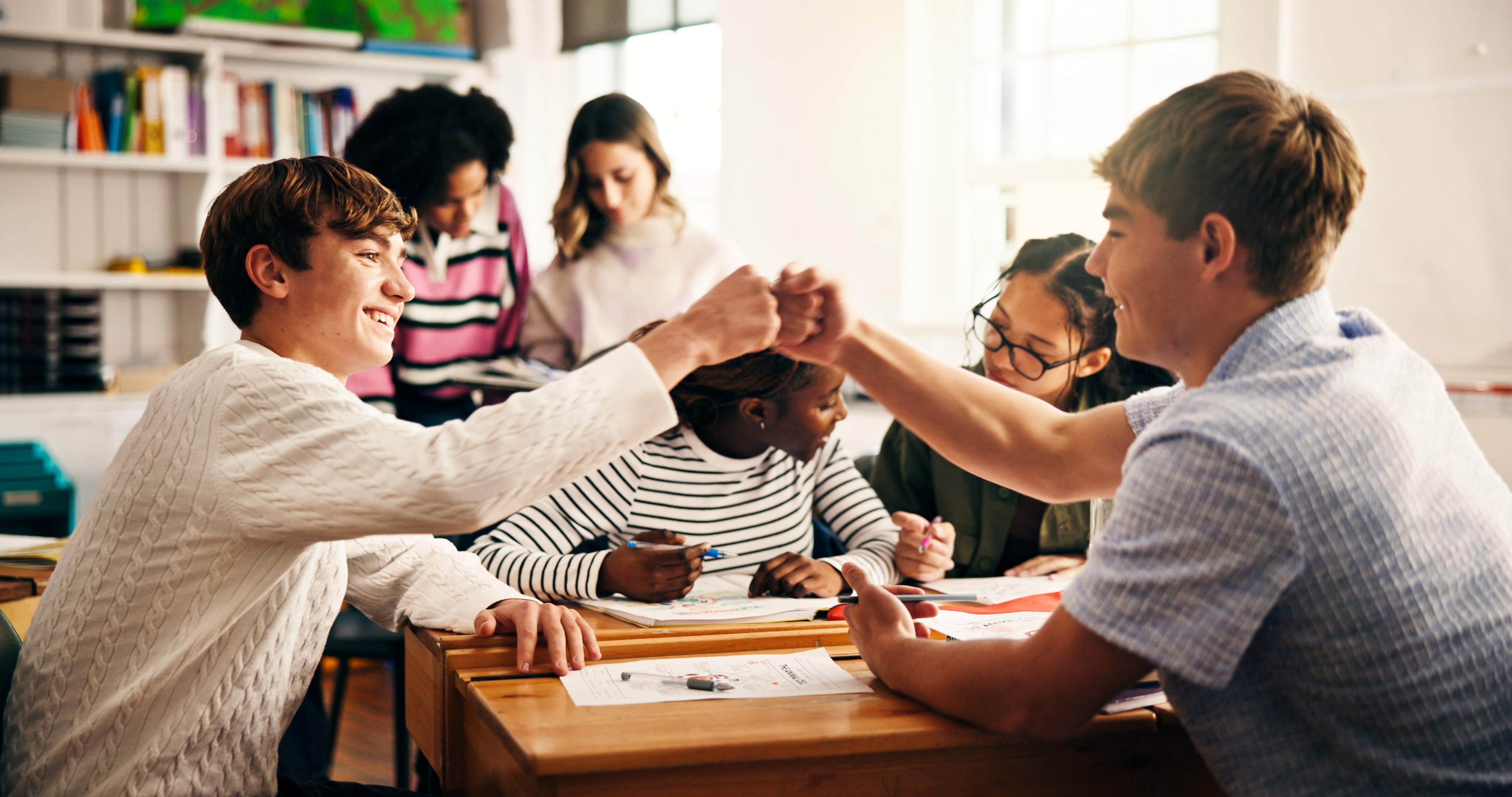 Group of teenagers fist bumping