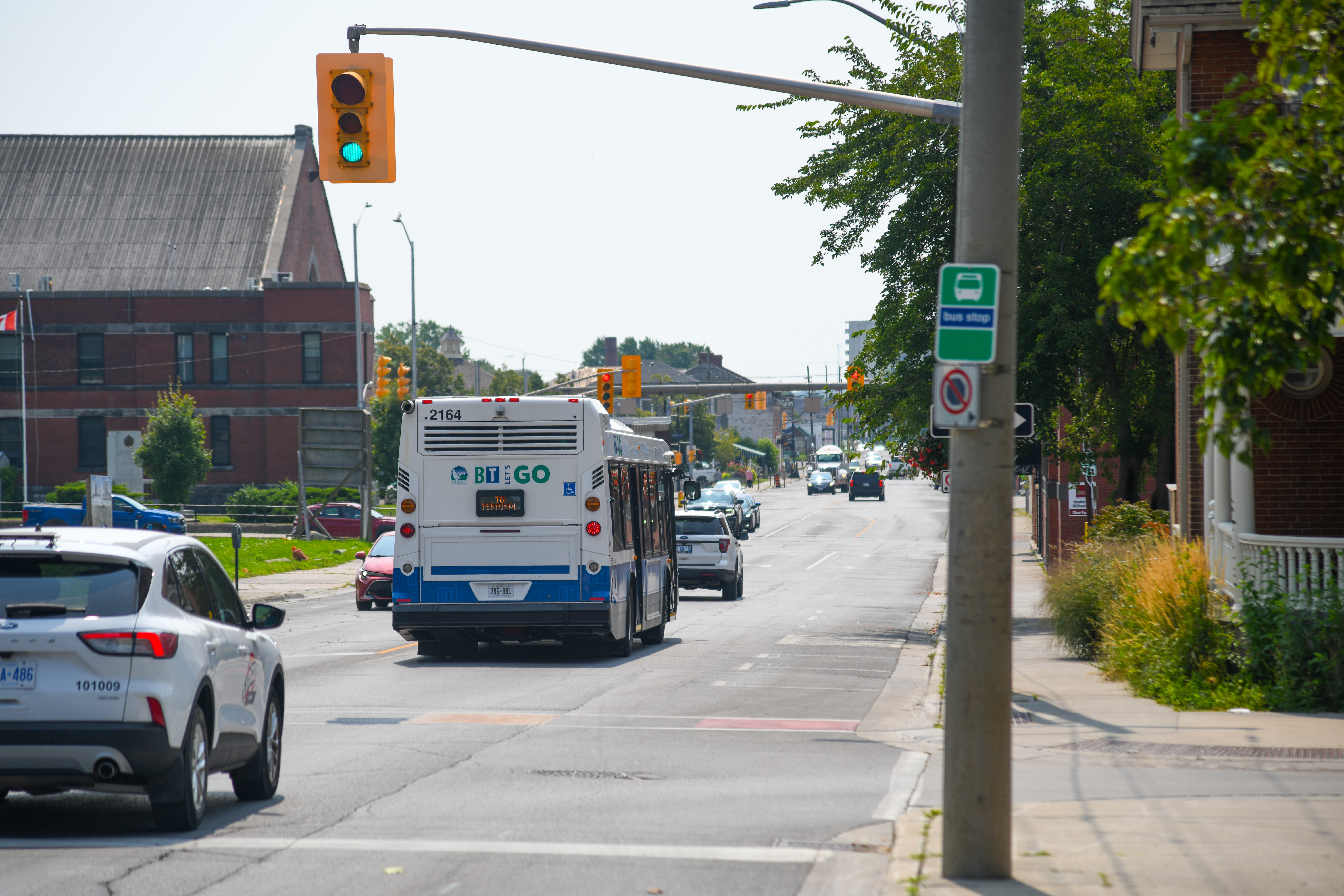 Photo of a transit bus driving down the road.