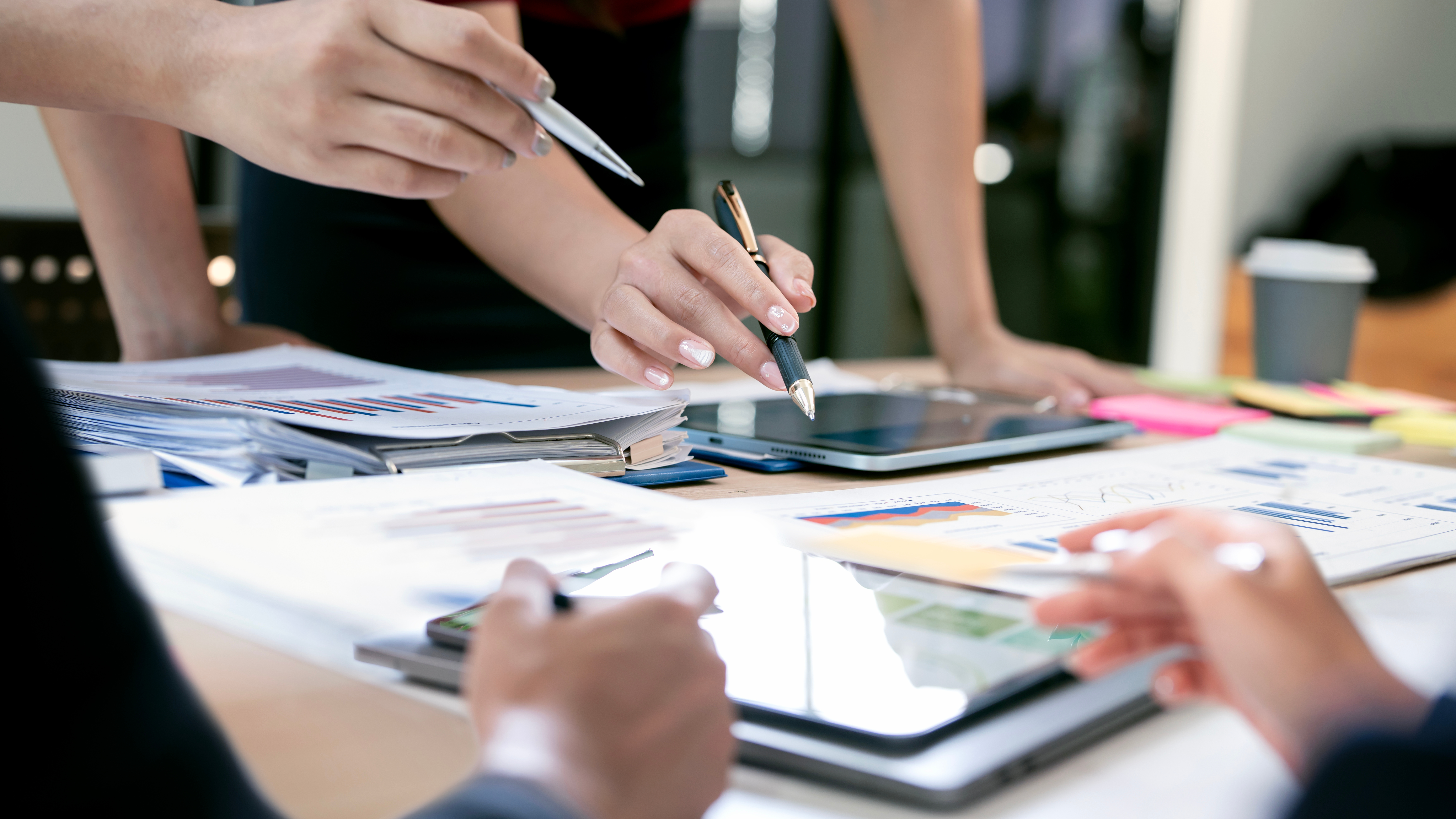 People looking at documents on a desk