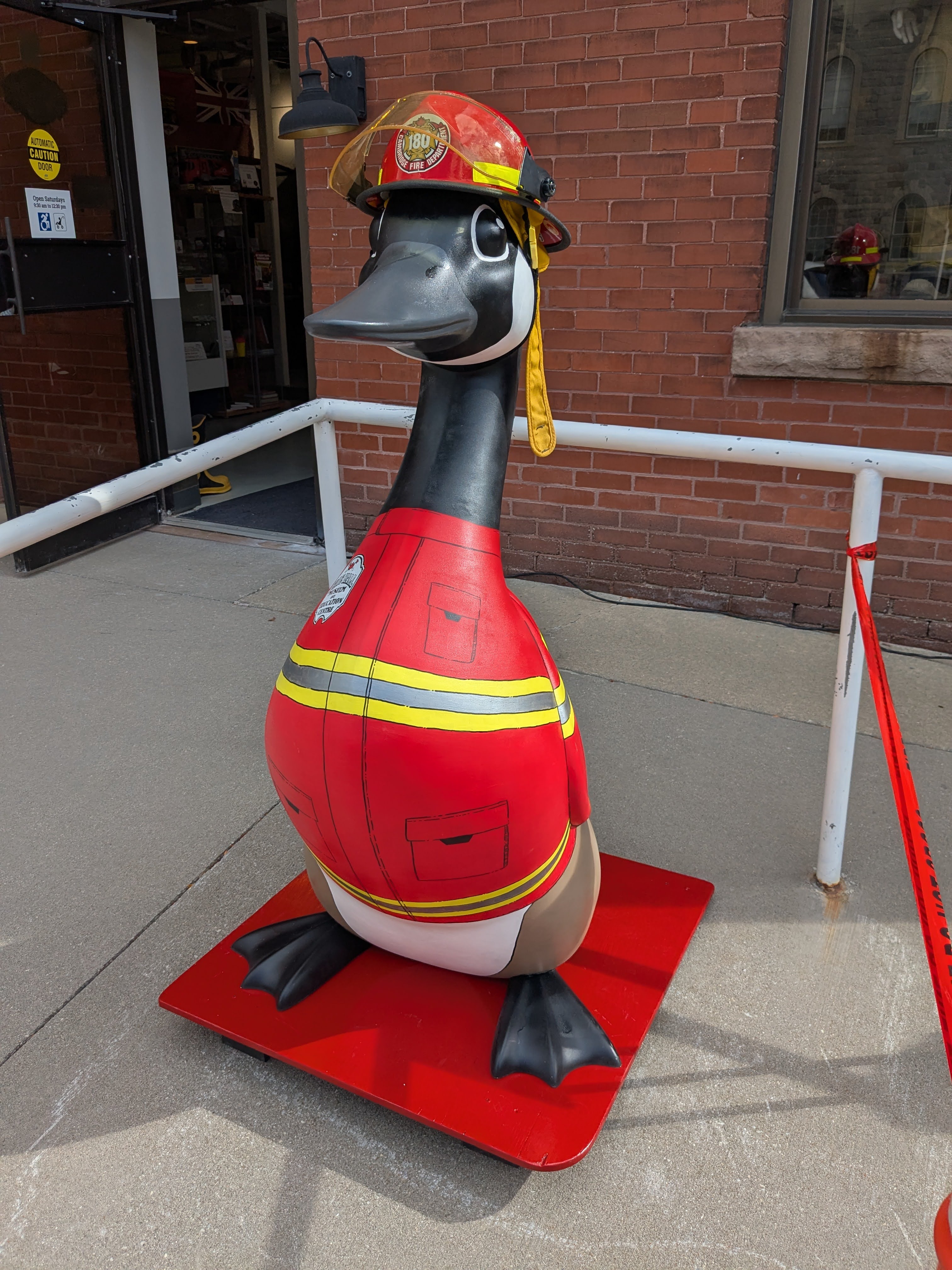 A 4.5-foot-tall fibreglass goose painted to look like a firefighter with red jacket and helmet.