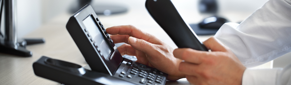 a person dialing on a phone