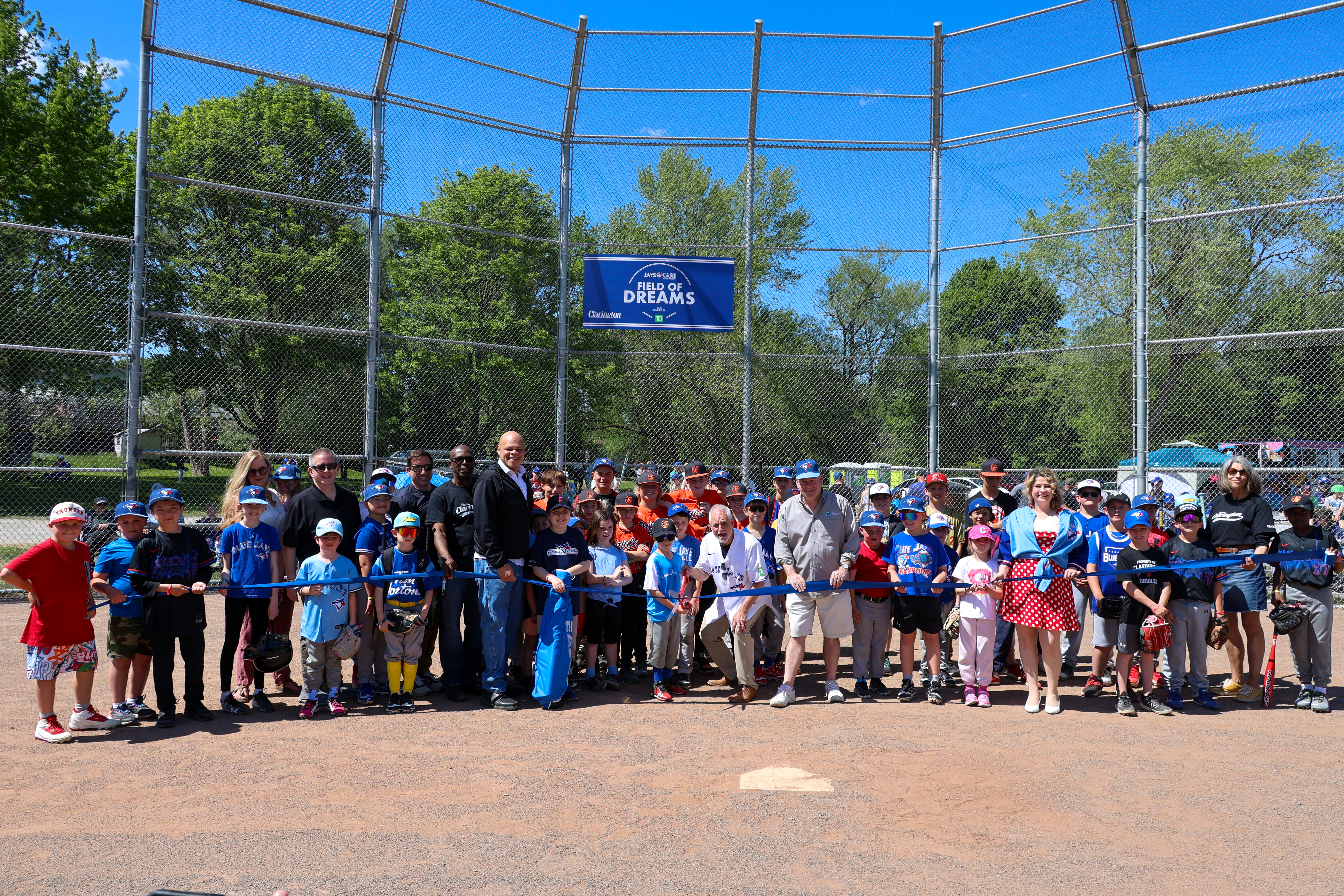 Clarington Mayor Adrian Foster and members of Council, along with dignitaries, Clarington Baseball Association and local athletes cut the ribbon to mark the official reopening of the Soper Creek Park baseball diamond.