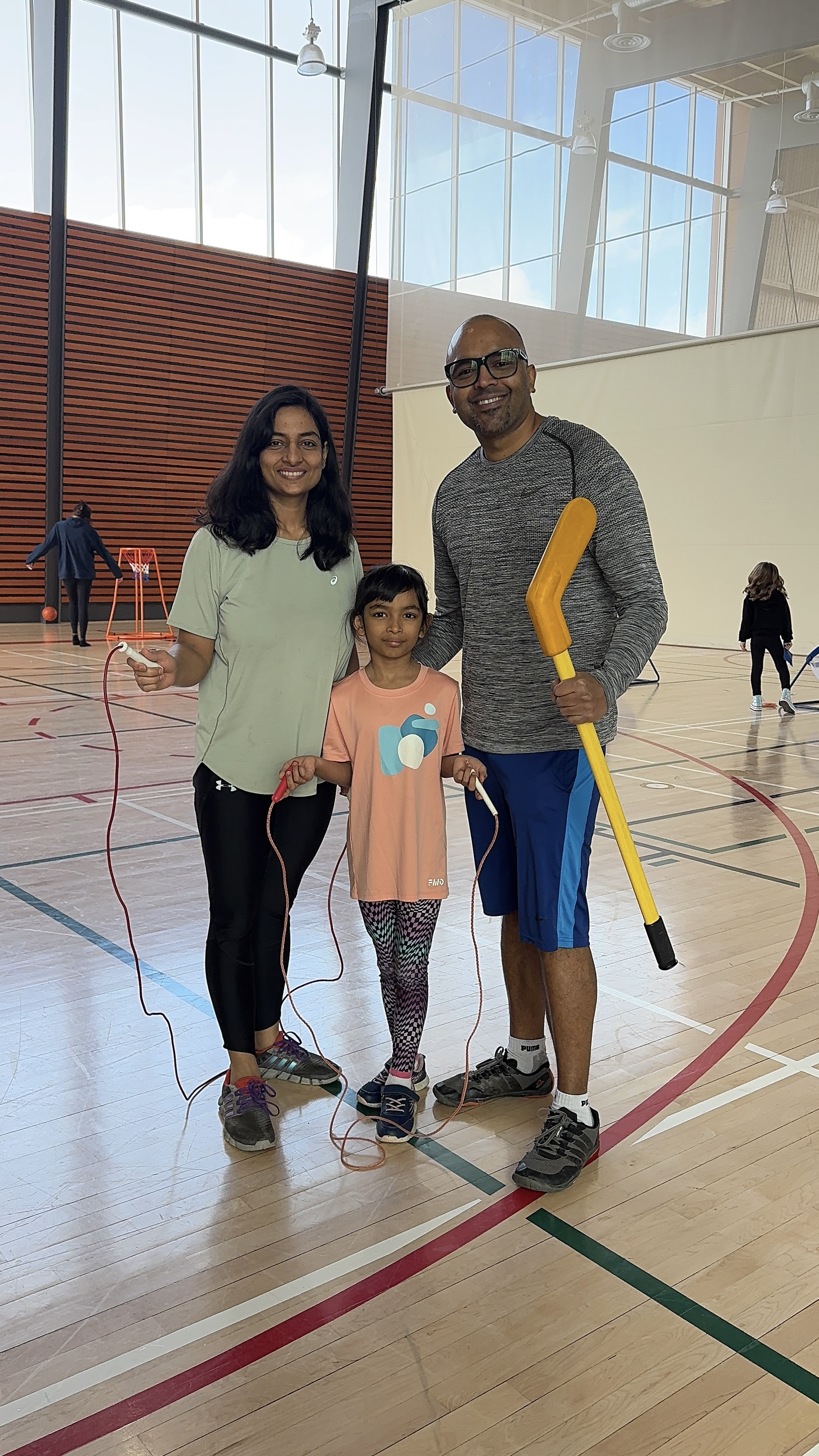 Mom, dad and child playing in the gym at Diane Hamre Recreation Complex on Family Day.