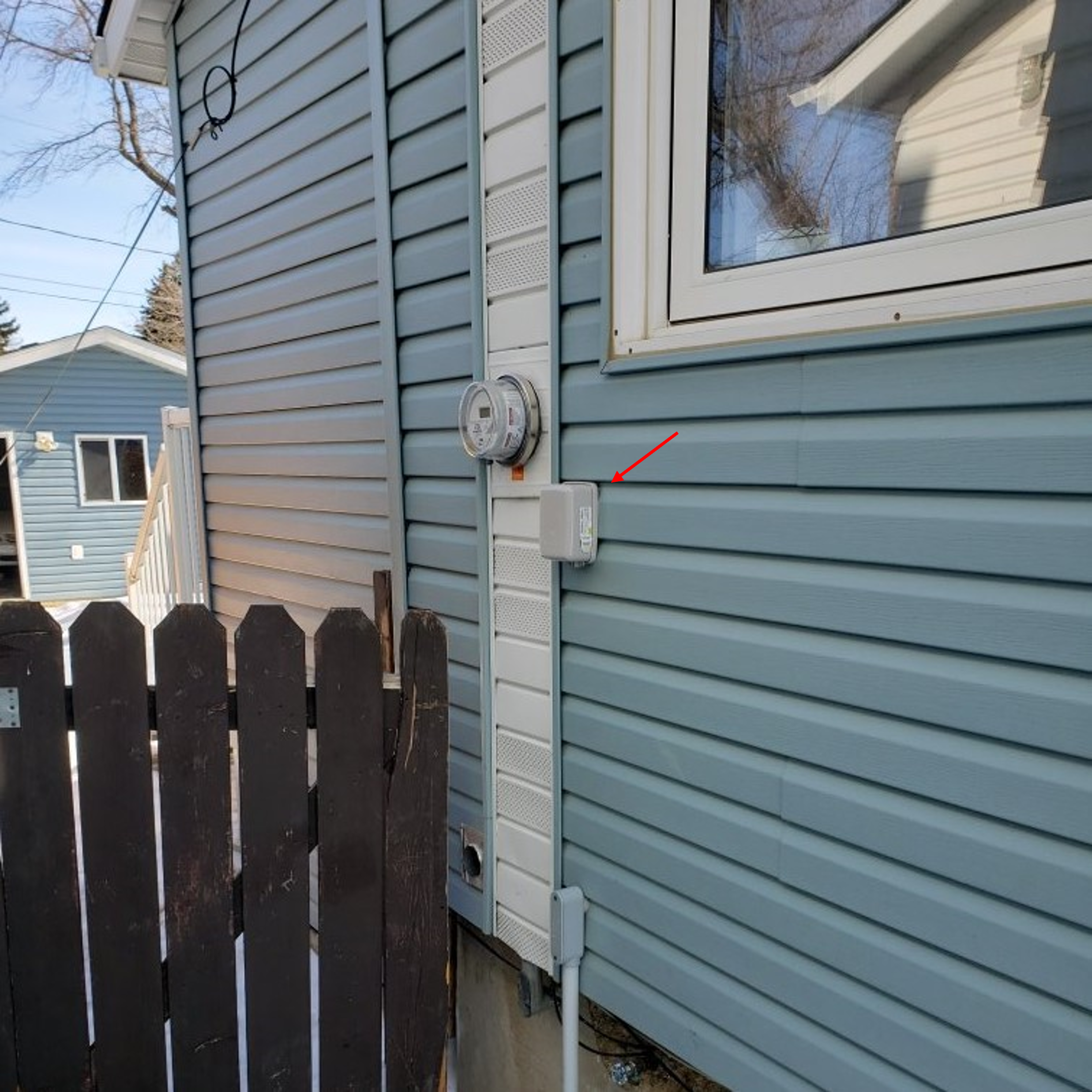 Image of a radio transmitter installed on the side of a house