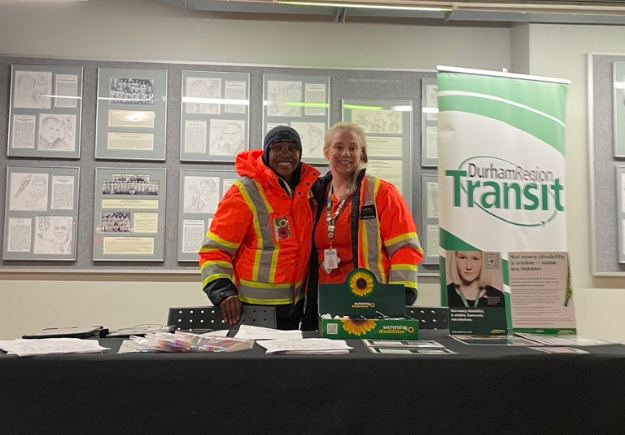 DRT ambassadors at an information table with box from the sunflower program.