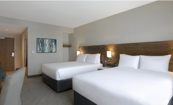Hotel guest room with two standard queen beds and desk