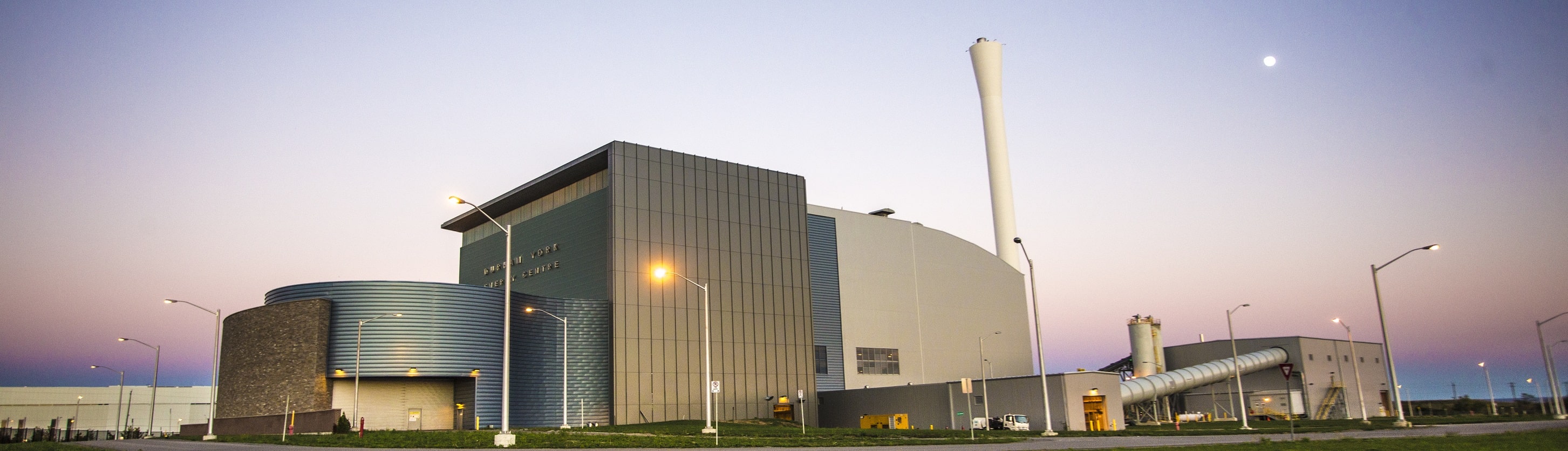 Exterior view of the Durham York Energy Centre building at night.