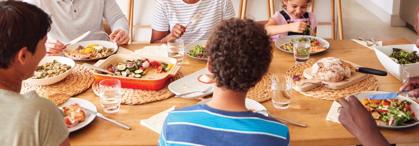 Family enjoying food at the dinner table