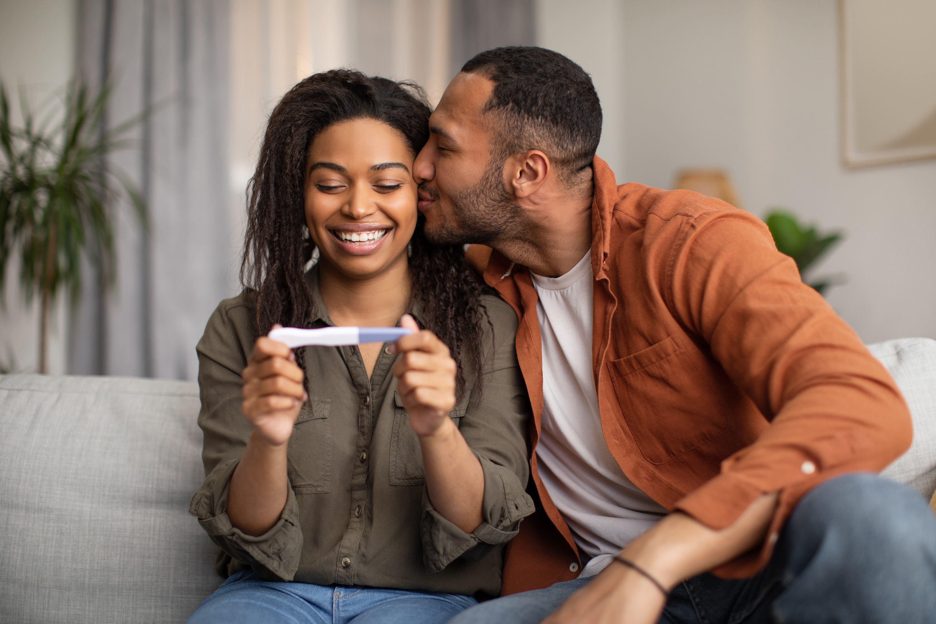 Happy couple holding a pregnancy test