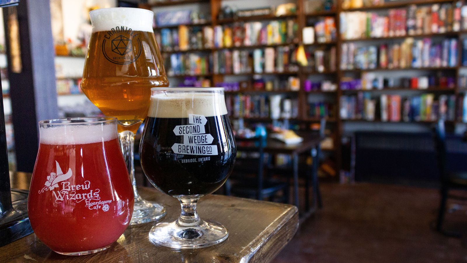 Image of three different glasses of beer sitting on a bar