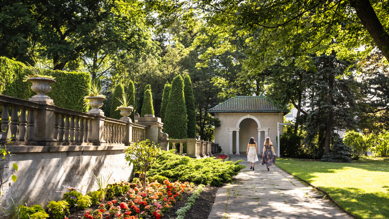 Two people walking through the gardens at Parkwood Estate in Oshawa, Ontario