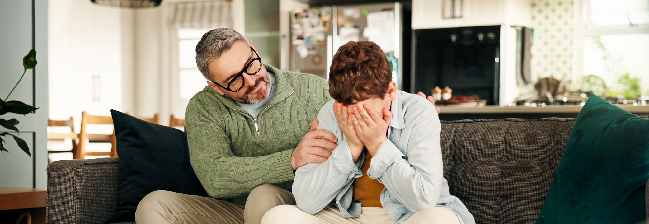 Father comforting son