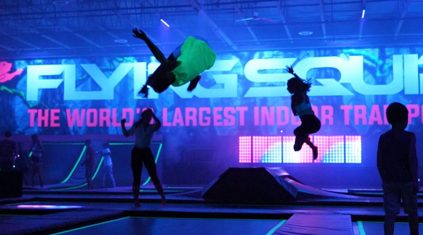 People jumping on indoor tramolines