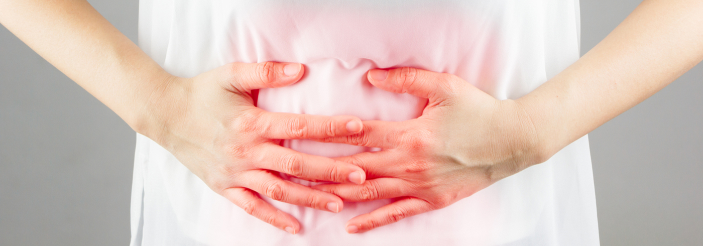A woman holding her stomach.