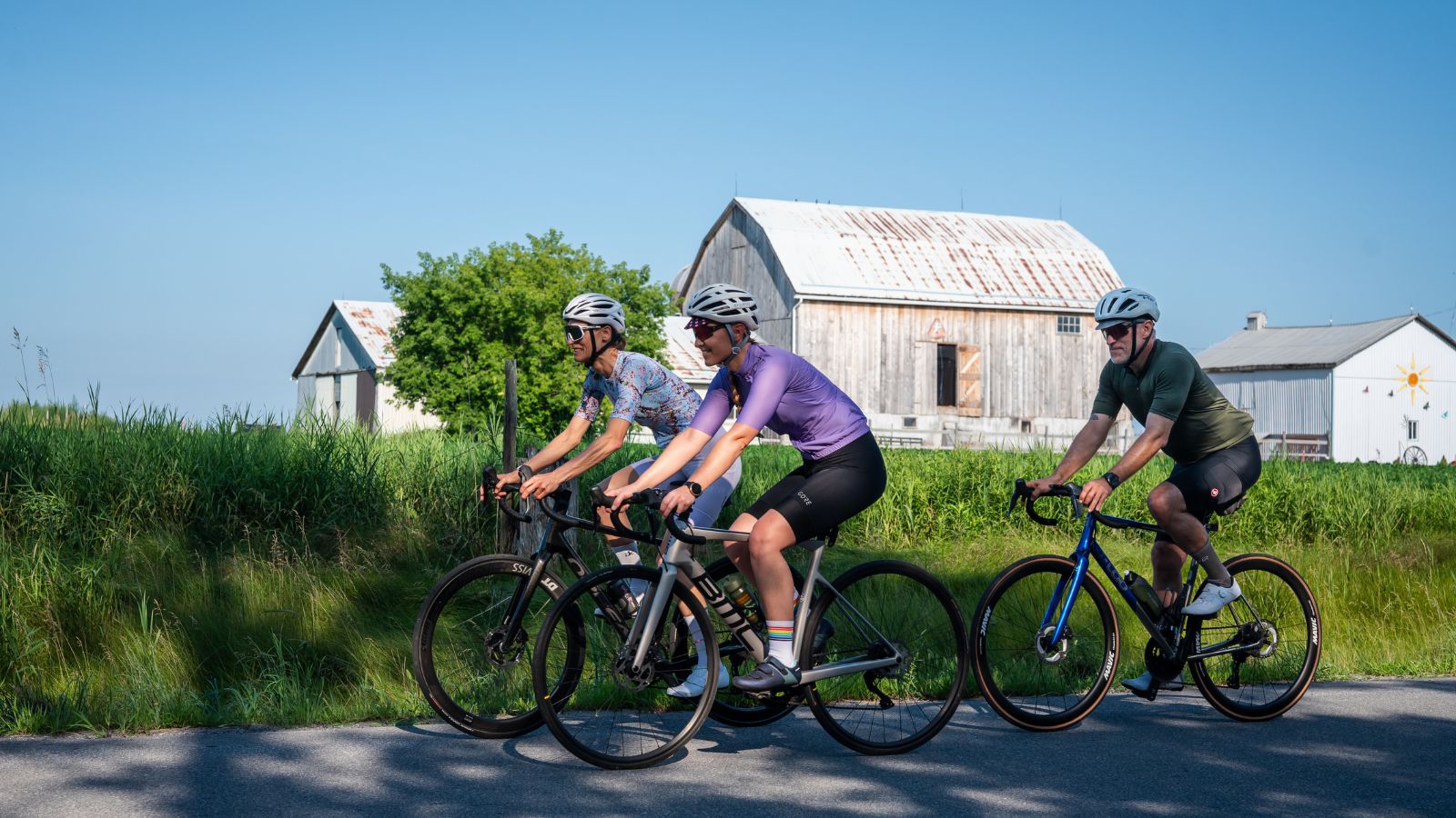 Three cyclists on a rural road in Durham Region, Ontario