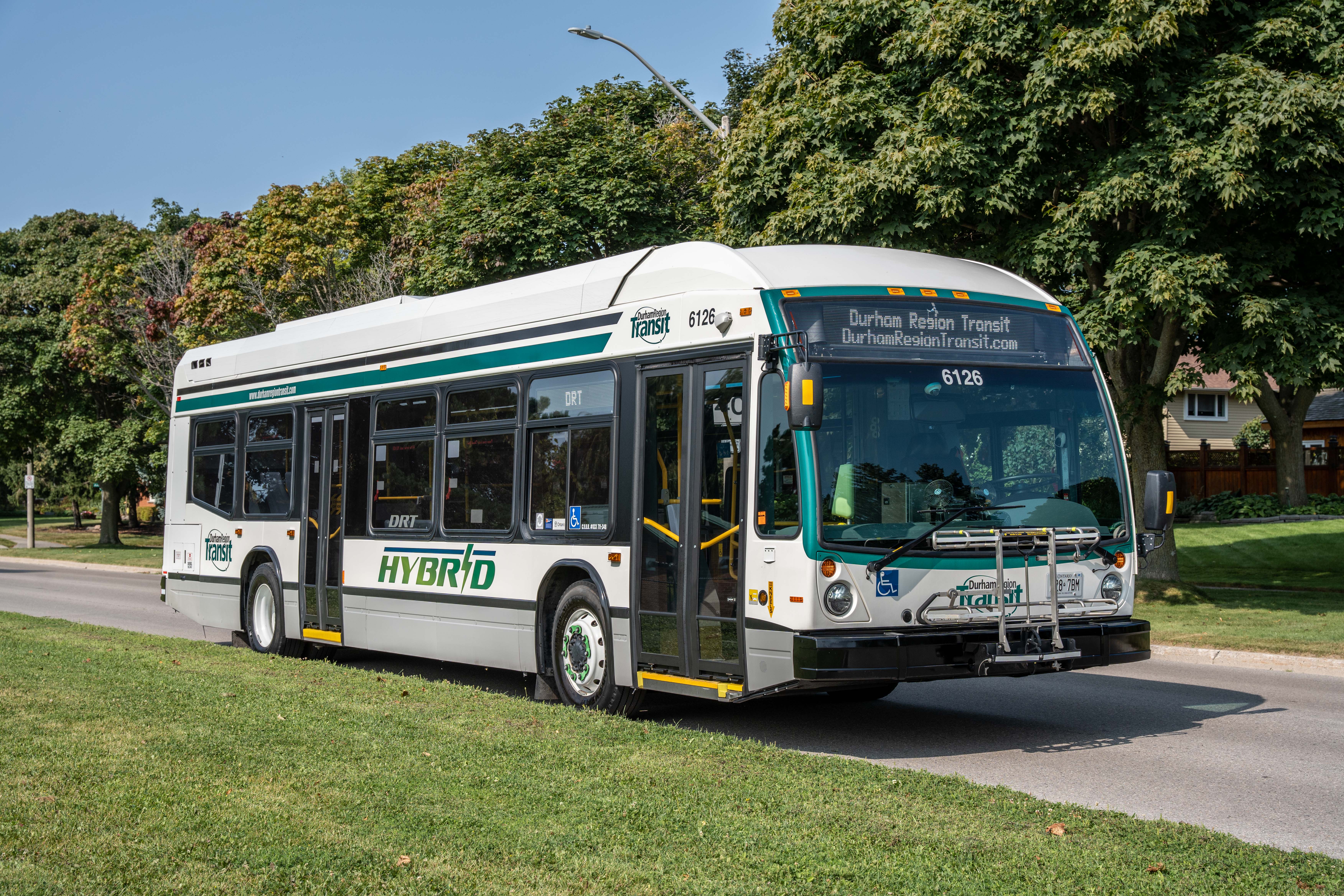 Image of Durham Region Transit bus on a tree lined street