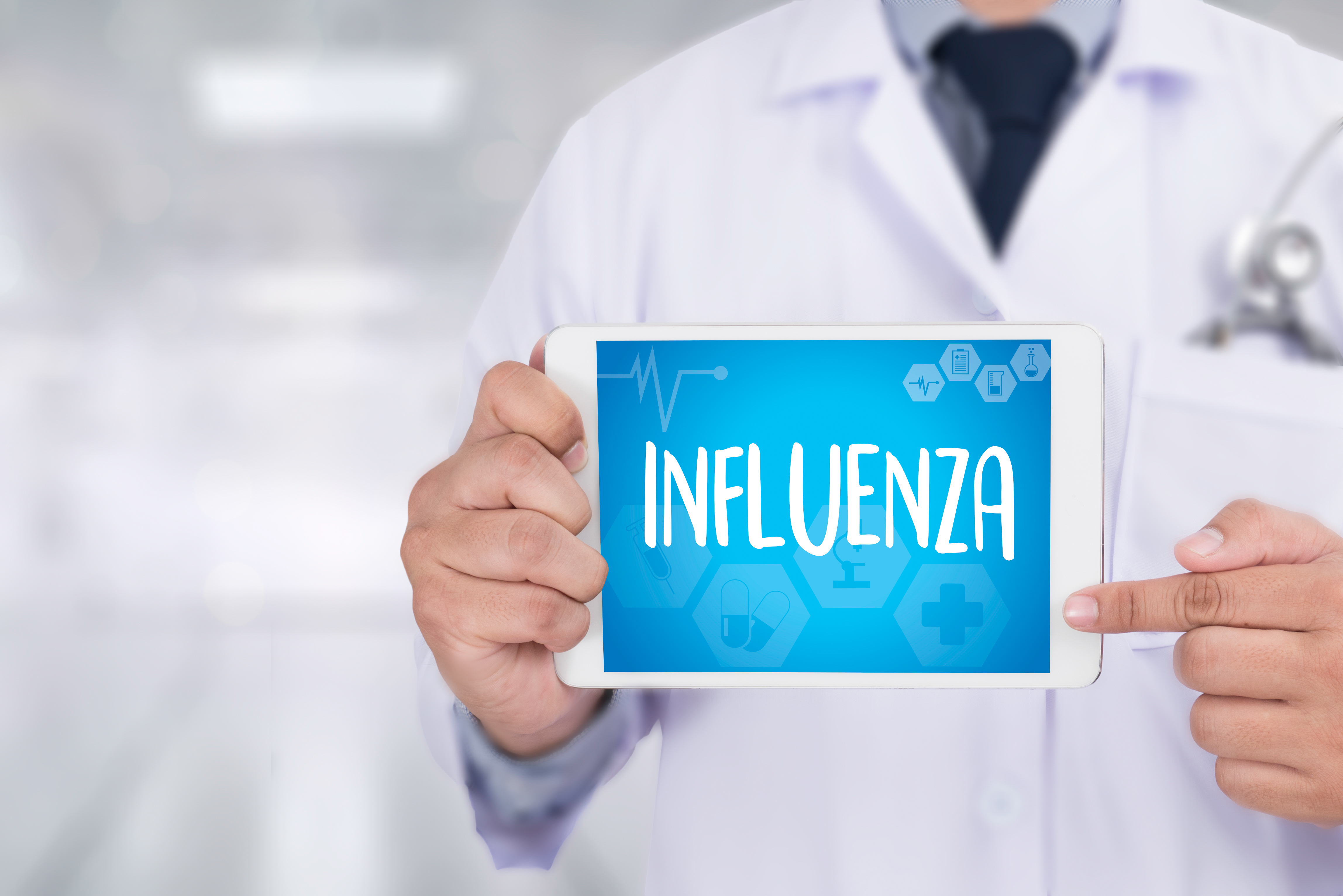 Health professional holding a tablet with the words "influenza" on it