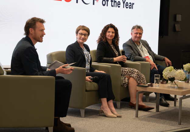 Panelists in mid conversation with the emcee.