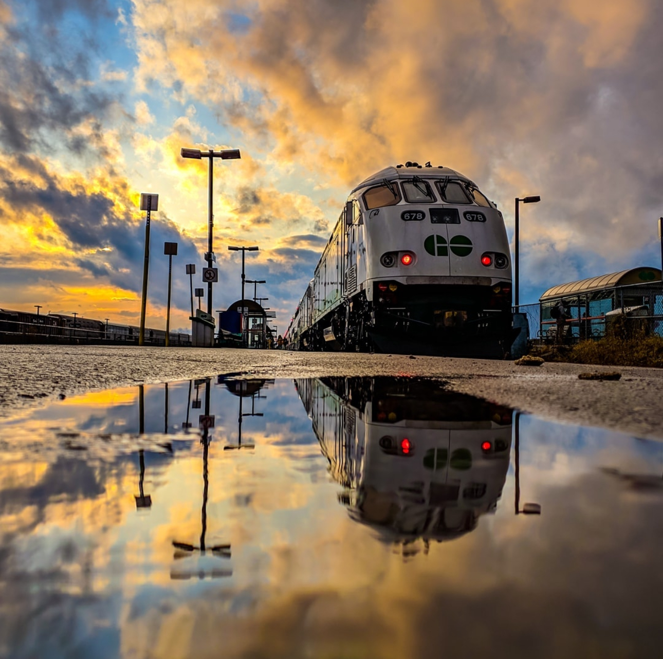 Image of Go Train at the station under a blue and orange sky