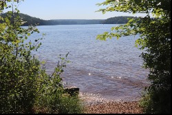 alt="View of Drag Lake through the trees."