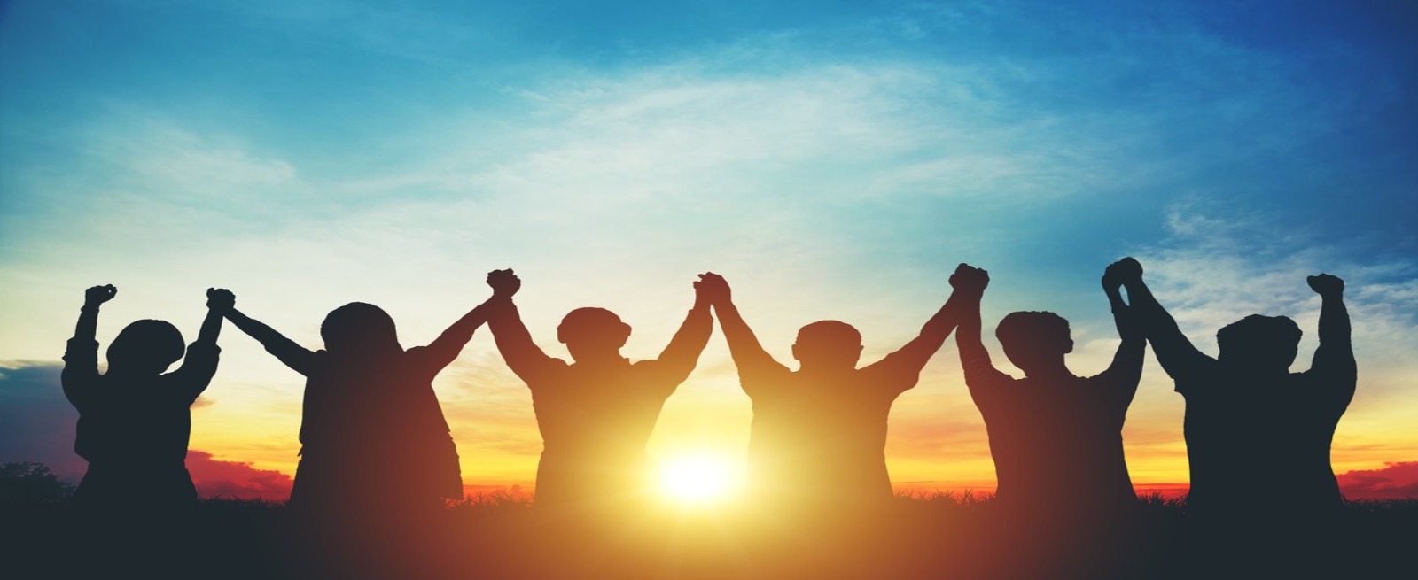 sunset and people hold up their hands