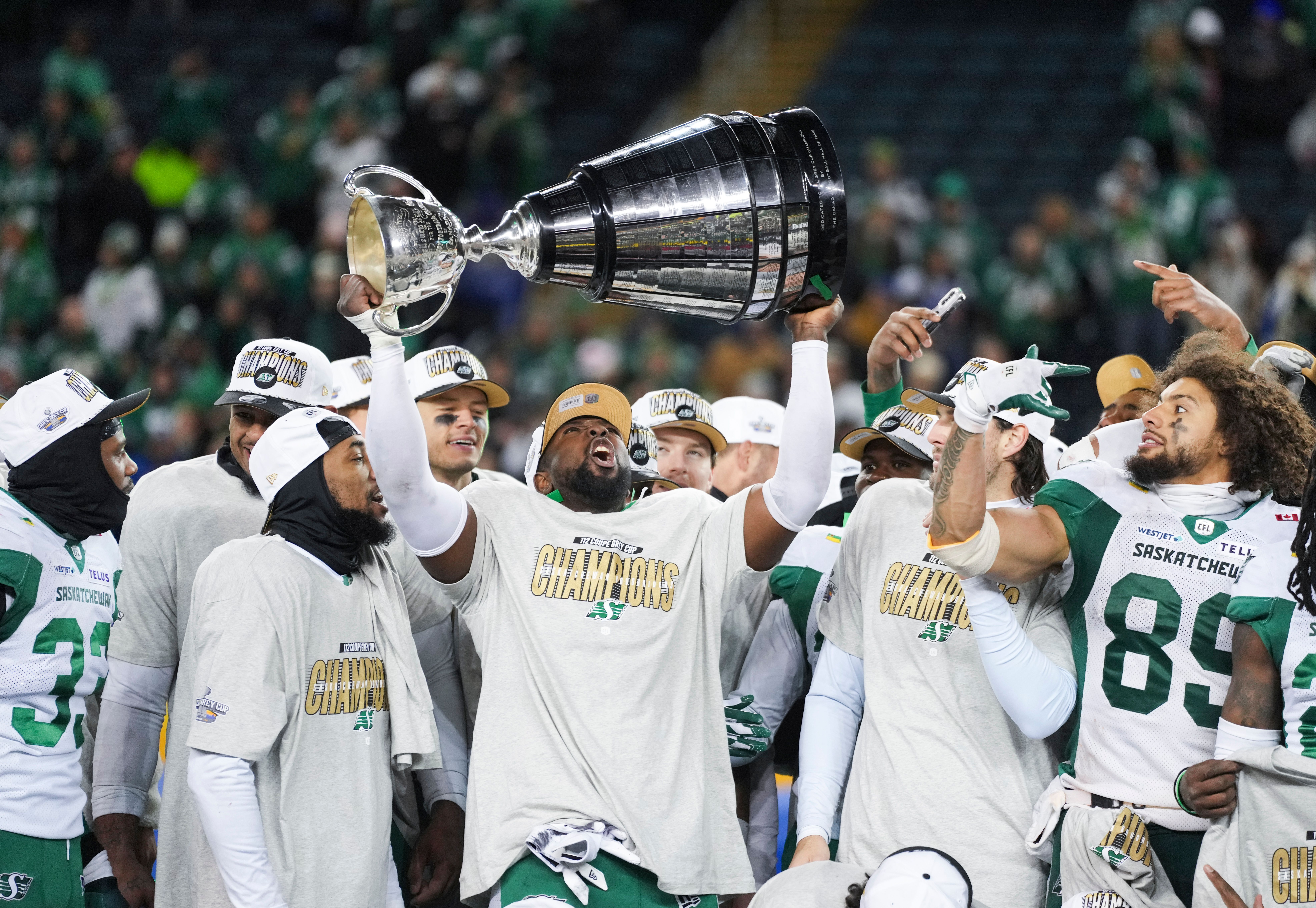 AJ Allen holding the Grey Cup