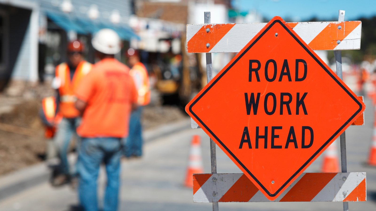 Construction site with "Road Work Ahead" sign. 