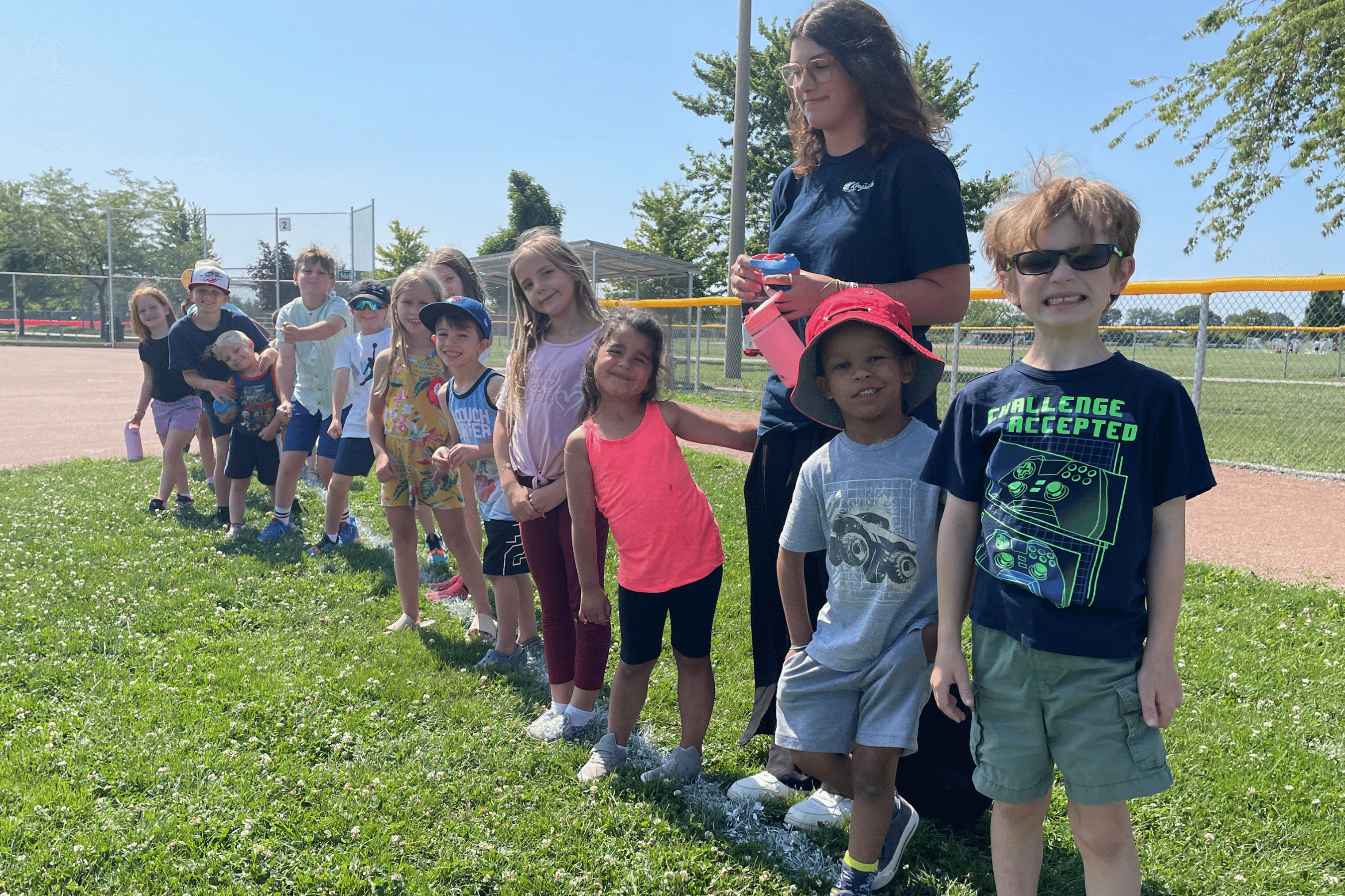 Kids line up ready for a run in a grassy field