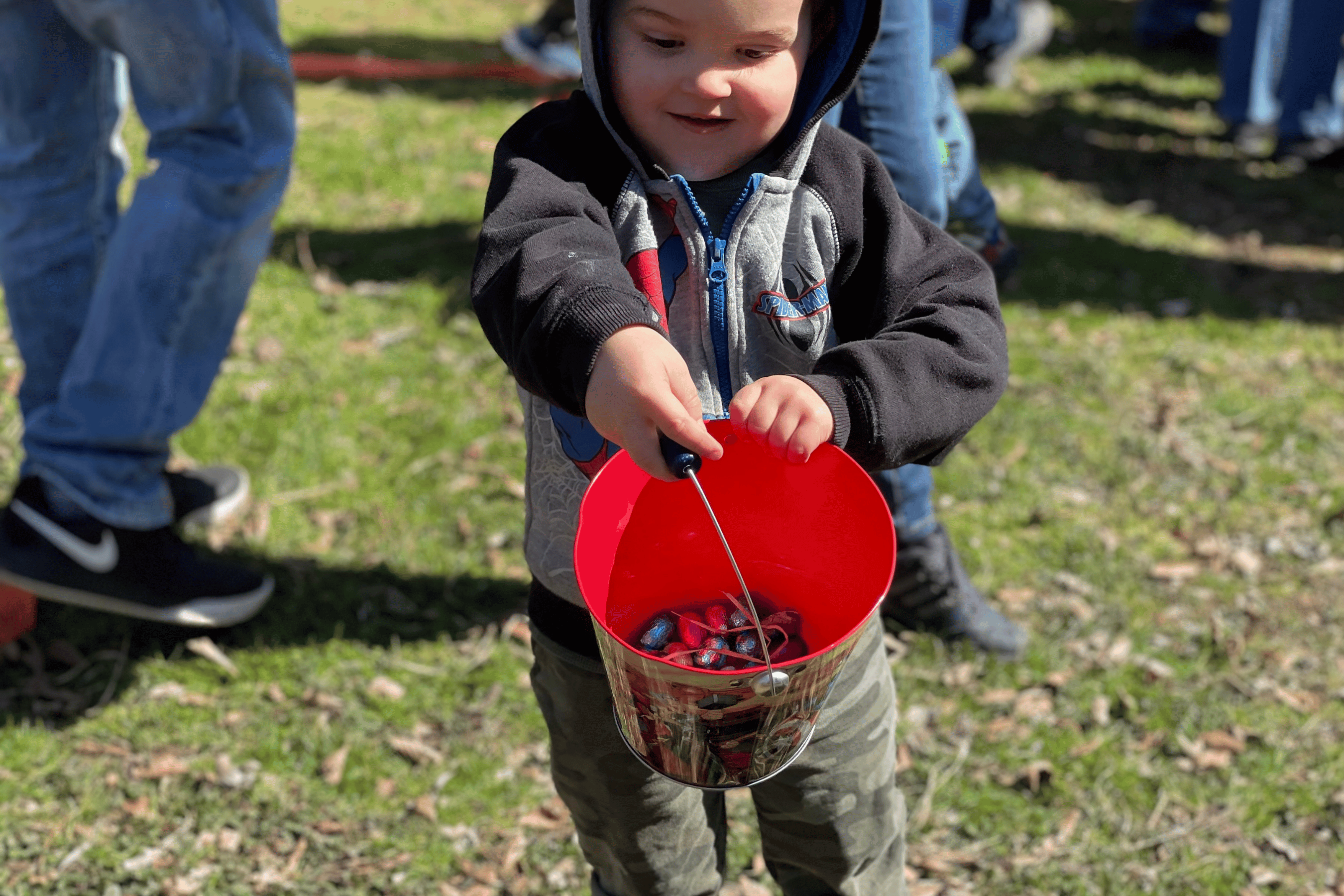 Boy shows off his bucket of Easter chocolate