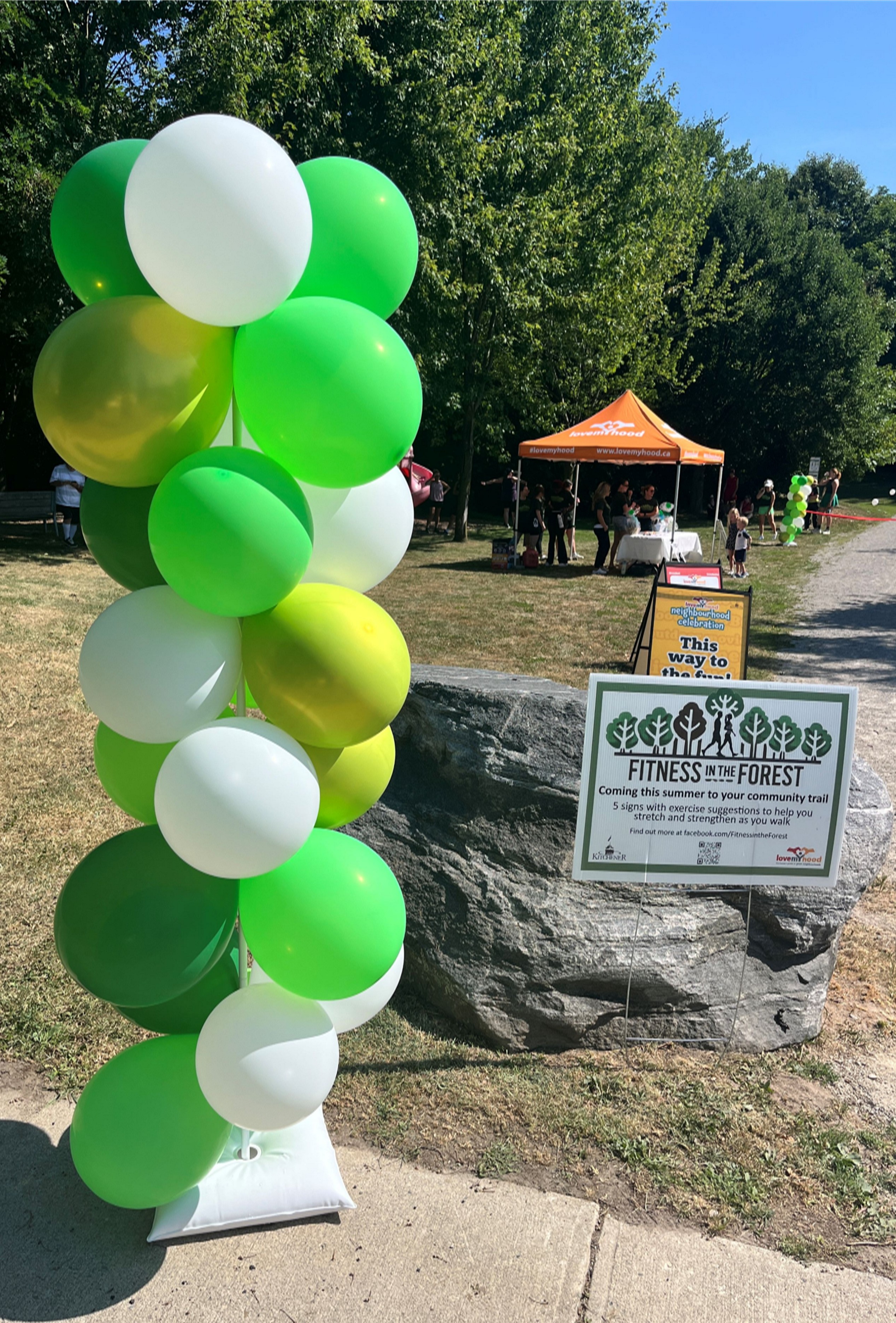A balloon column and sign announcing the project