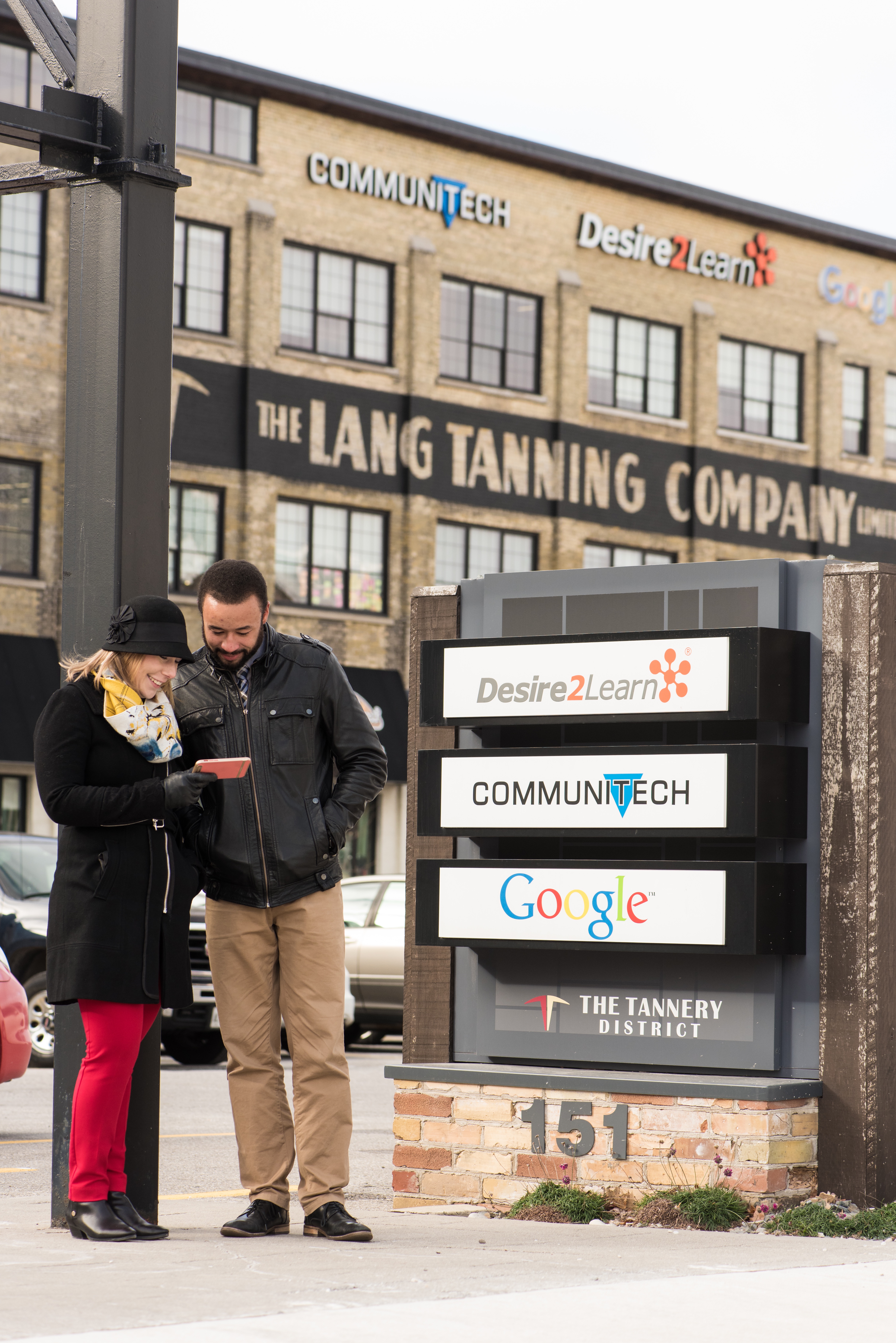 2 people standing in front of local businesses in Kitchener