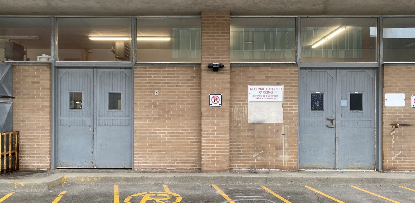 Exterior shot of two double doors on a brick building