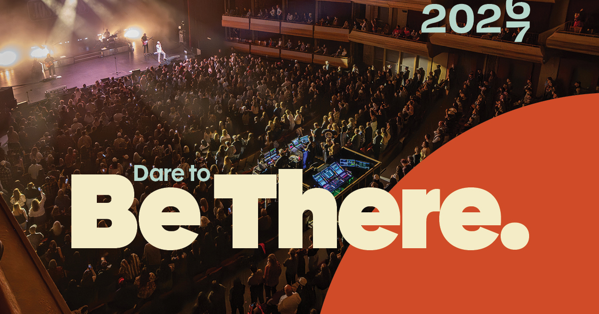 Photo of crowd in audience with 2027 dare to be there written on top