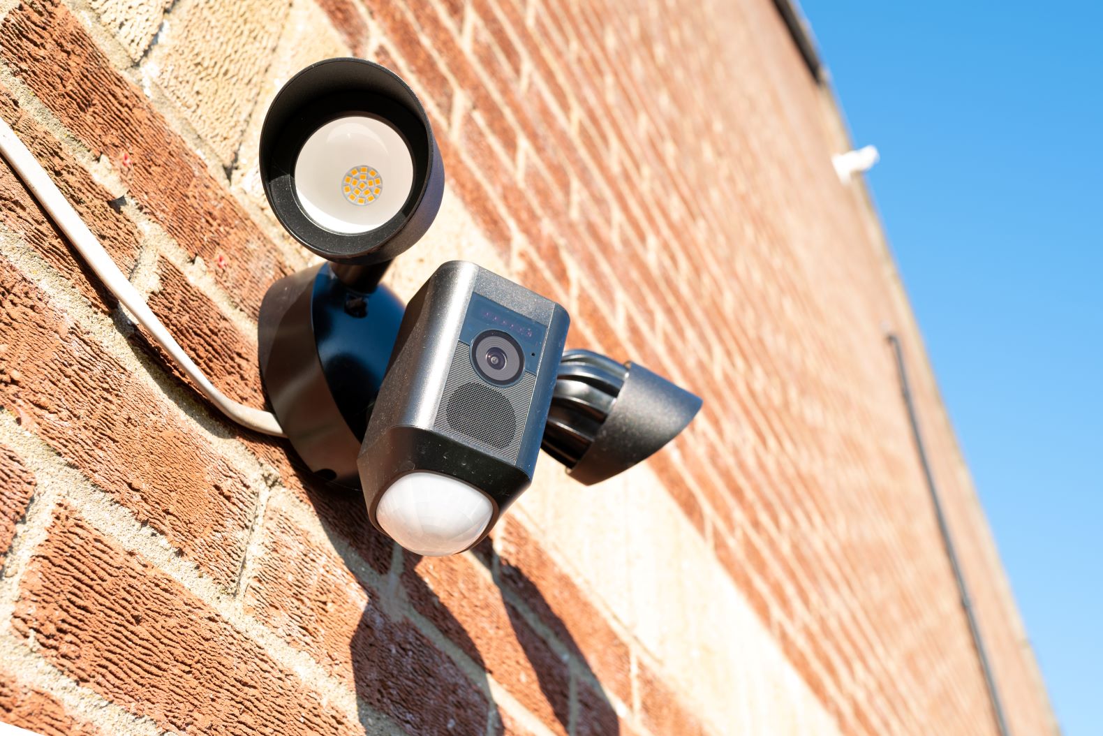 Photo of a flood light on a brick wall