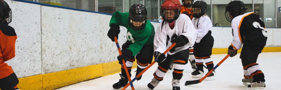 Kids playing hocking on indoor rink