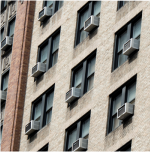 apartment building with air conditions in window