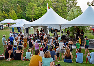 Crowd sitting near festival tents