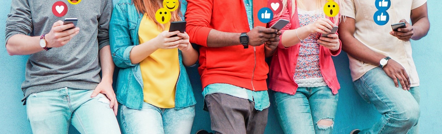 Teens leaning against wall, all on cell phones