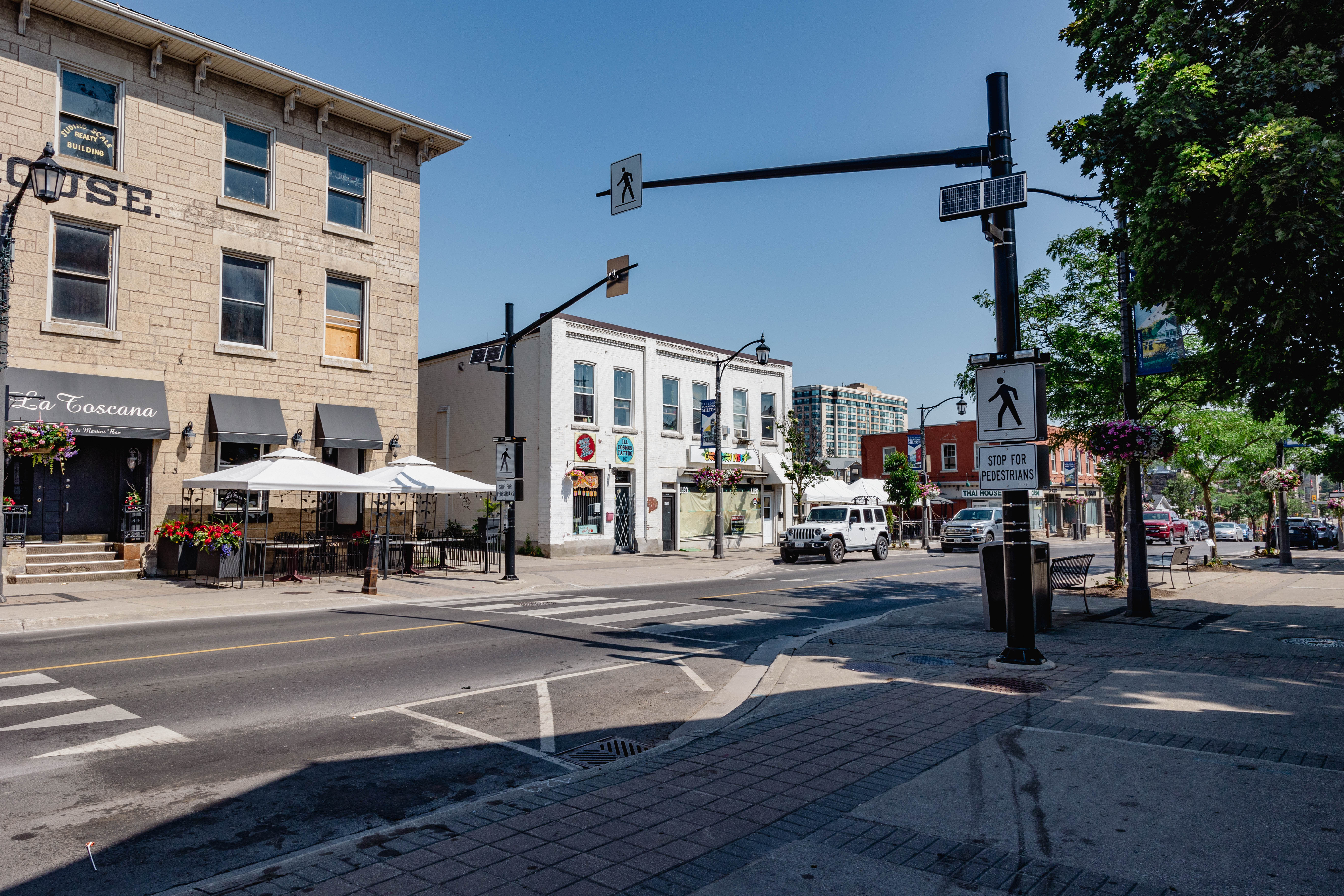 Pedestrian crossing with overhead flashing beacons at an intersection