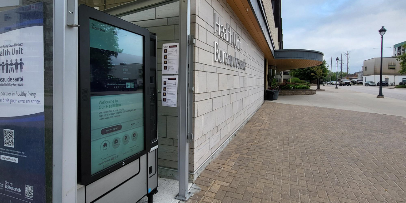 Image of a touch-screen, health and wellness supply vending machine outdoors