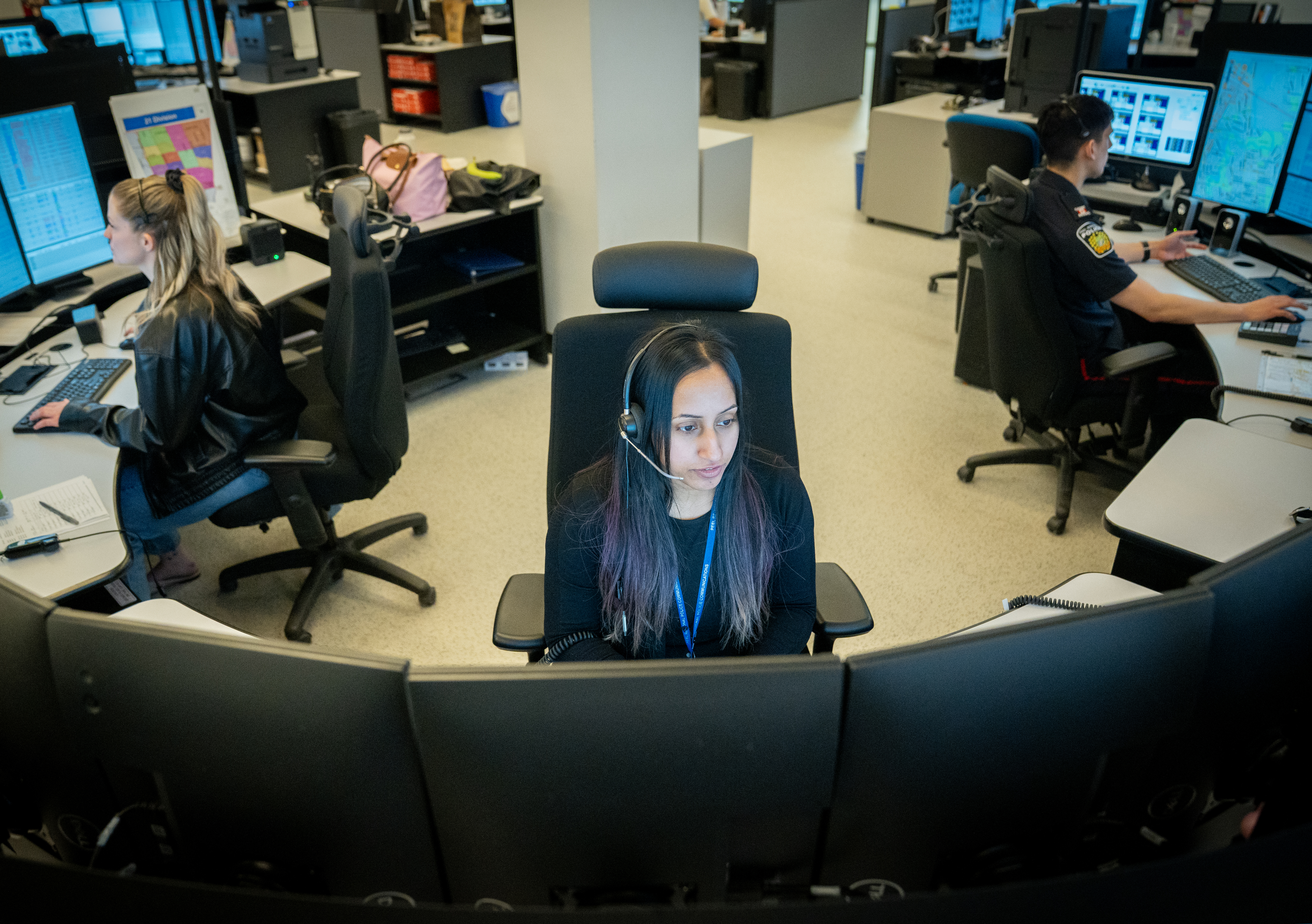 Police dispatchers working at computers