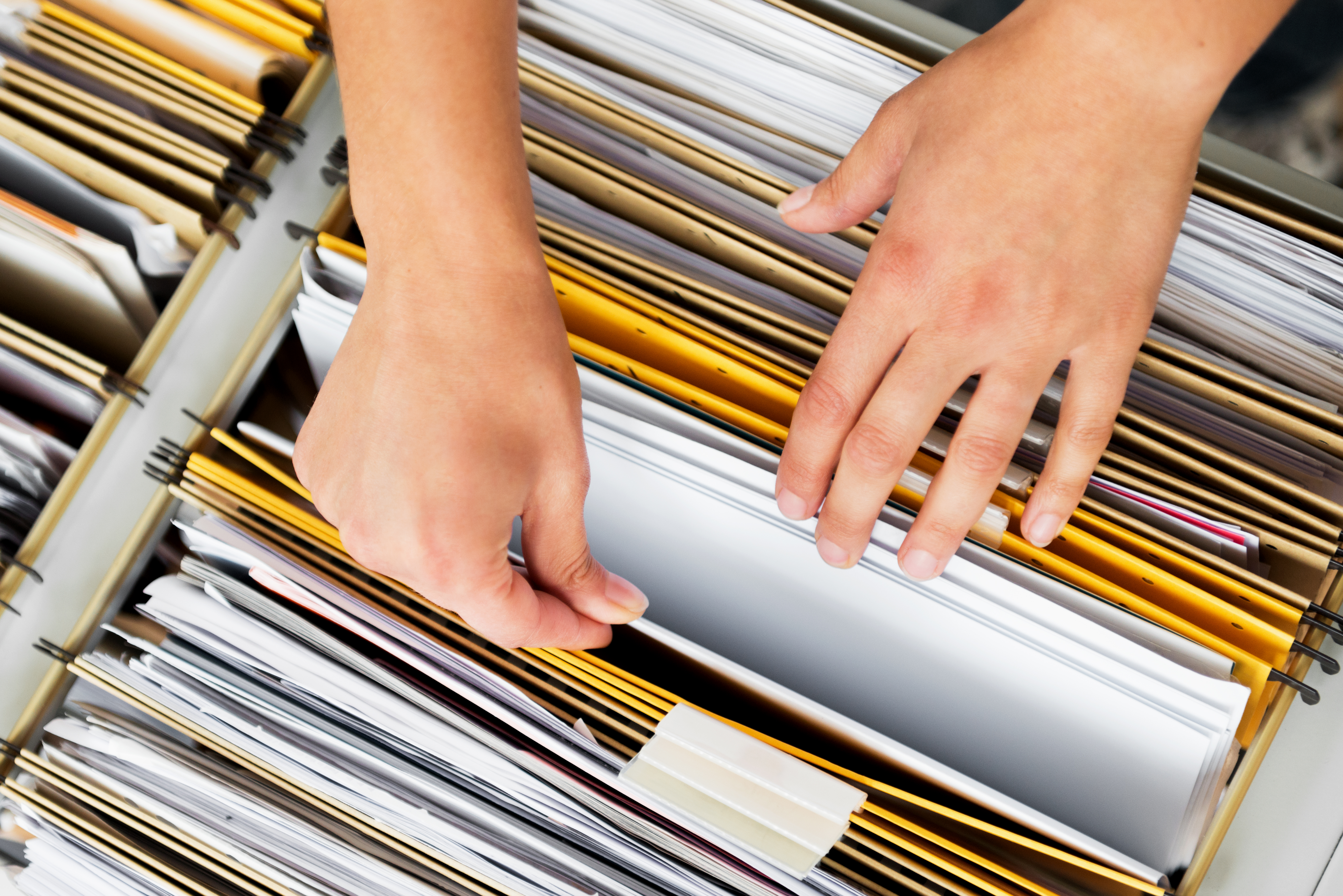 Hand sorting through folders